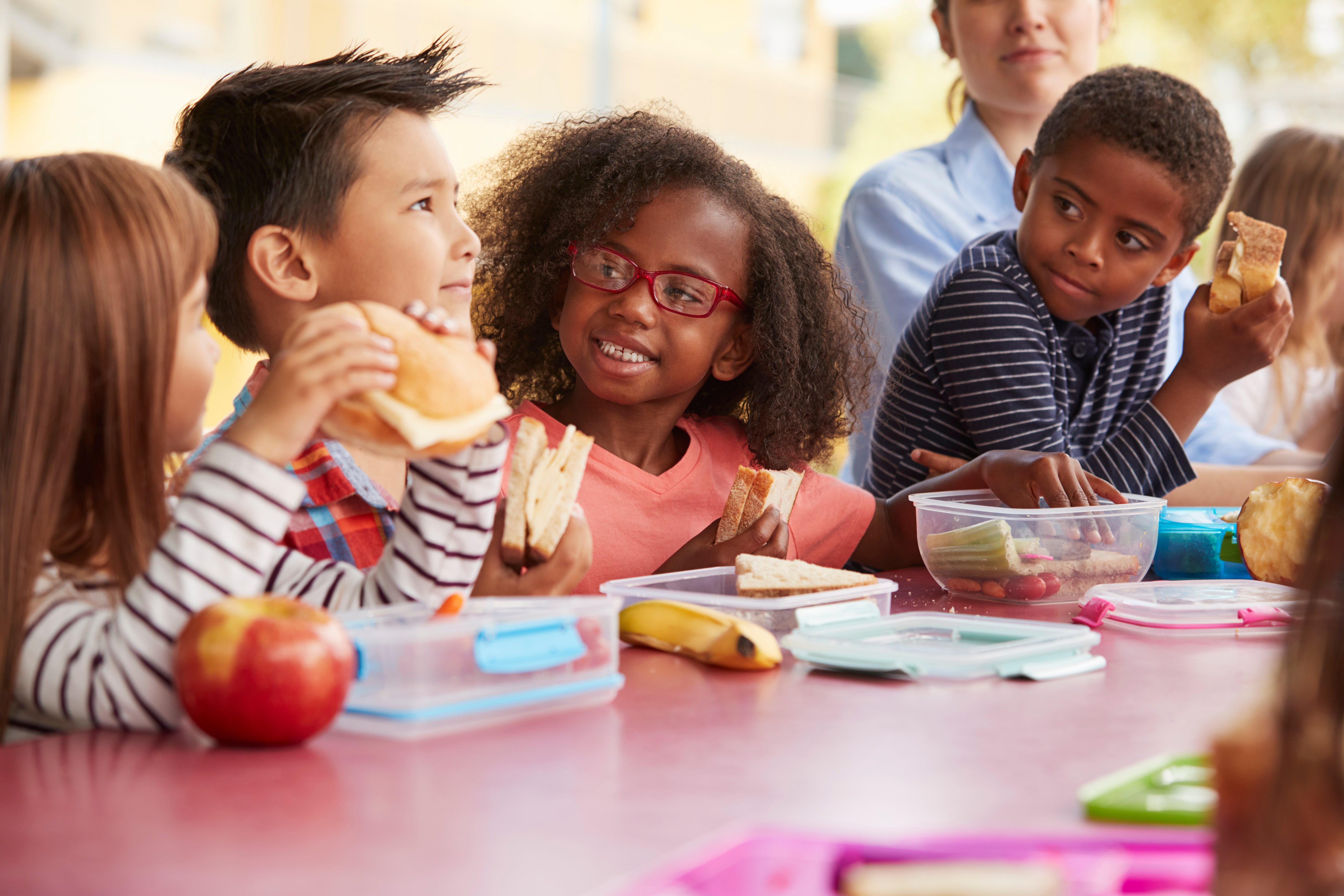 toddlers happy eating lunch together